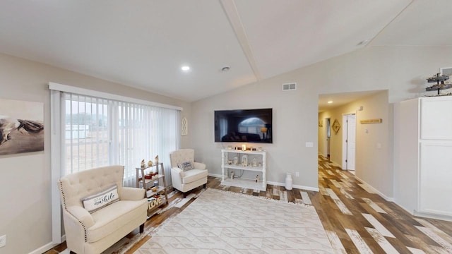 sitting room with hardwood / wood-style floors and lofted ceiling