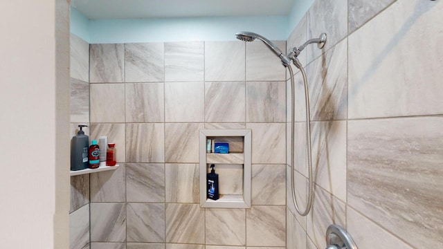 bathroom with tiled shower