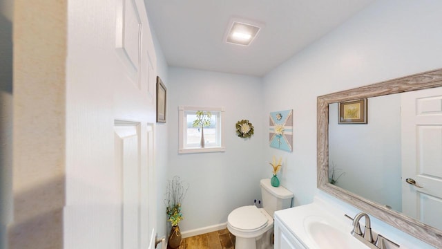 bathroom featuring hardwood / wood-style floors, vanity, and toilet