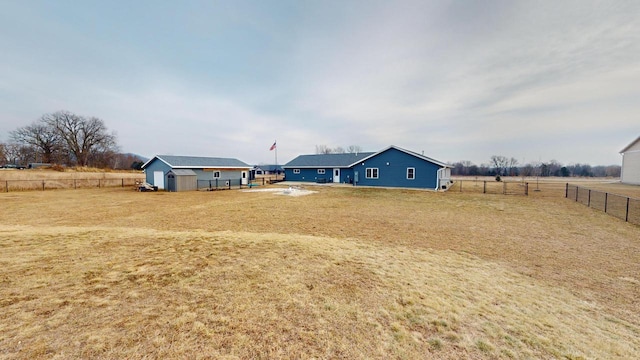 view of yard with an outbuilding and a rural view