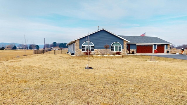 single story home with a garage and a front yard