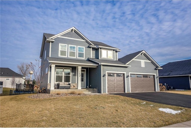 craftsman inspired home featuring covered porch and a front yard