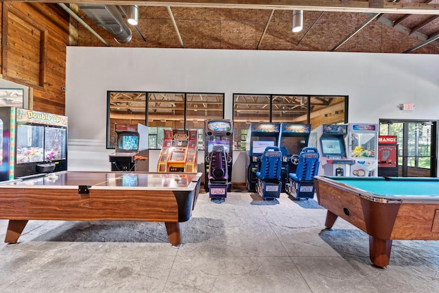 game room featuring pool table, wooden walls, and concrete floors