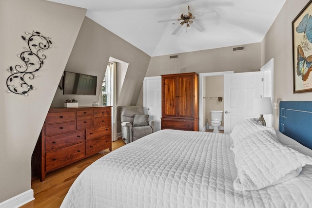 bedroom with ceiling fan, lofted ceiling, light wood-type flooring, and ensuite bath
