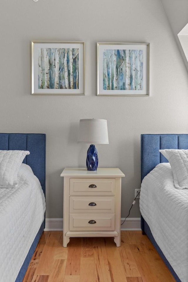 bedroom with light hardwood / wood-style flooring and vaulted ceiling