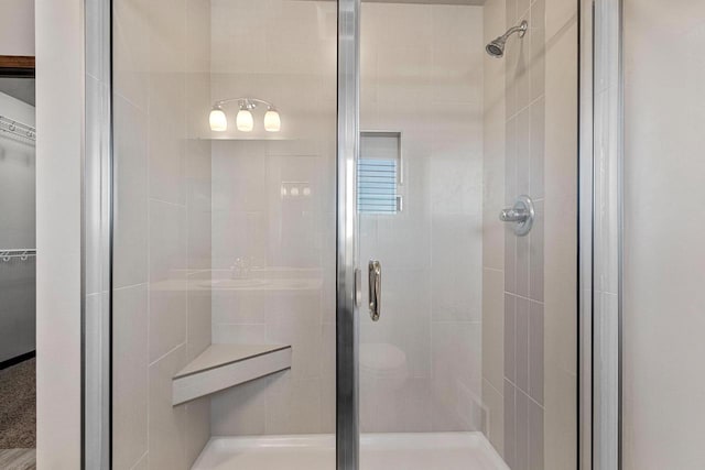 bathroom with a shower with door