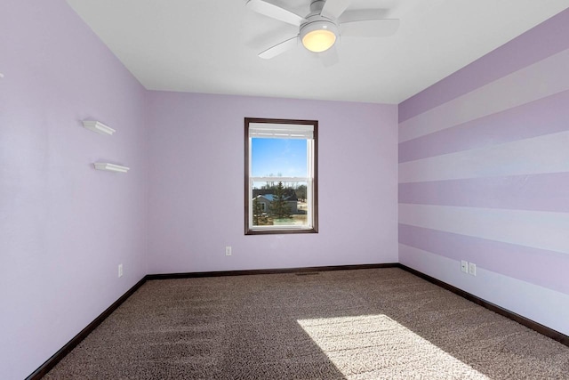 unfurnished room with carpet and ceiling fan