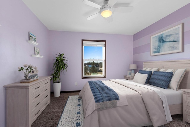 bedroom with ceiling fan and dark carpet