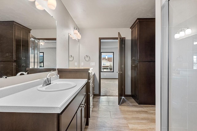 bathroom with ceiling fan and vanity