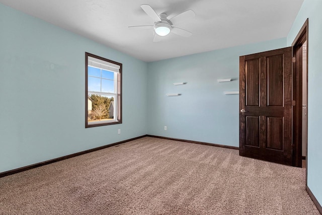 unfurnished room featuring ceiling fan and light colored carpet