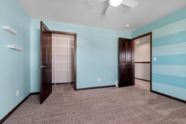 unfurnished bedroom with ceiling fan, a closet, and carpet floors