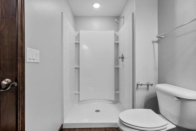 bathroom with a shower and toilet