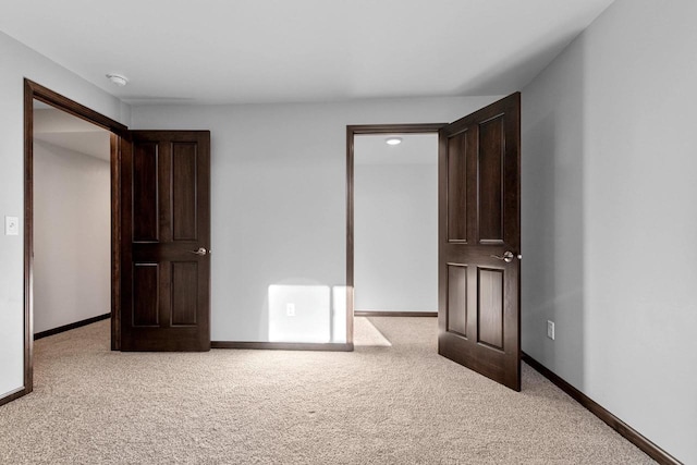 unfurnished bedroom featuring light colored carpet