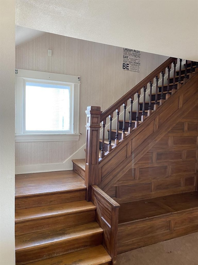 stairway with lofted ceiling