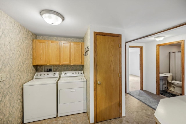 laundry area with cabinets and separate washer and dryer