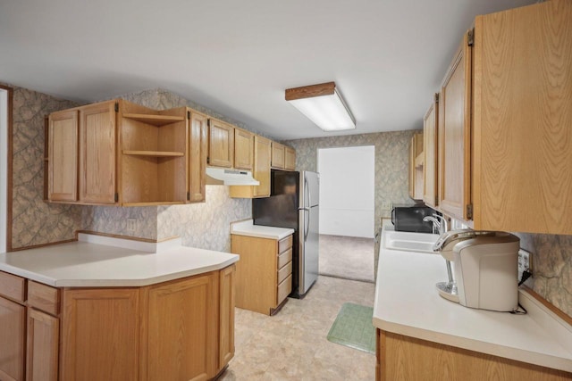 kitchen with sink and stainless steel refrigerator