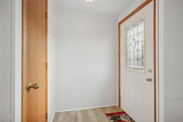 foyer entrance featuring ornamental molding and light wood-type flooring