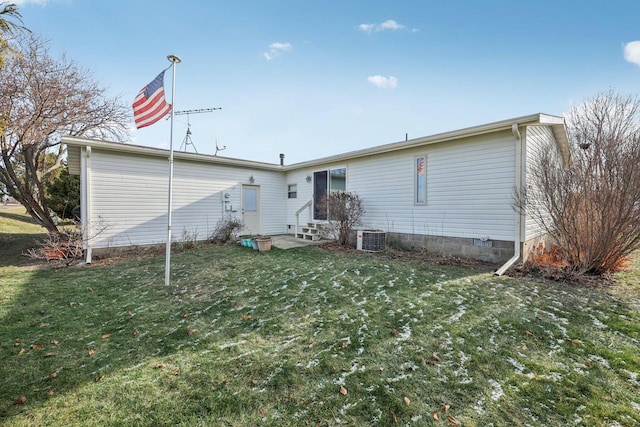 back of property with a lawn and central AC unit