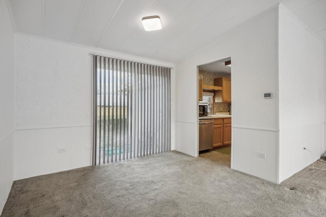 unfurnished living room with light colored carpet and vaulted ceiling