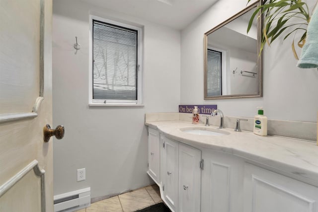 bathroom featuring tile patterned flooring, vanity, and baseboard heating