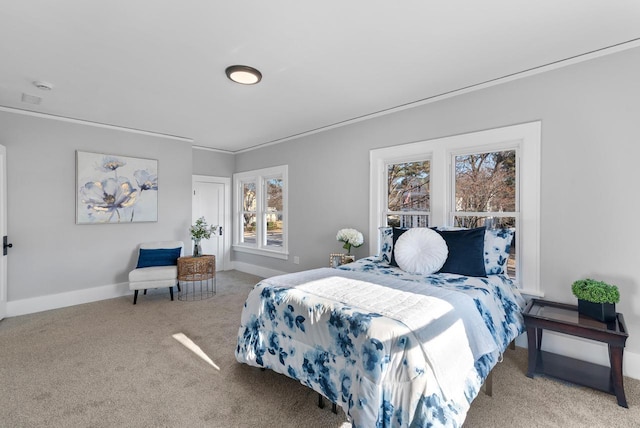 bedroom with light colored carpet and crown molding