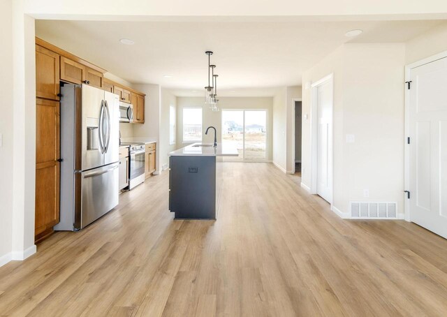 6407 Prairie Wood Dr, Mcfarland, WI 53558 - kitchen featuring a sink, visible vents, light wood-style floors, light countertops, and appliances with stainless steel finishes