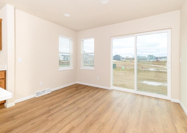 6407 Prairie Wood Dr, Mcfarland, WI 53558 - unfurnished room with light wood-style flooring, visible vents, and baseboards