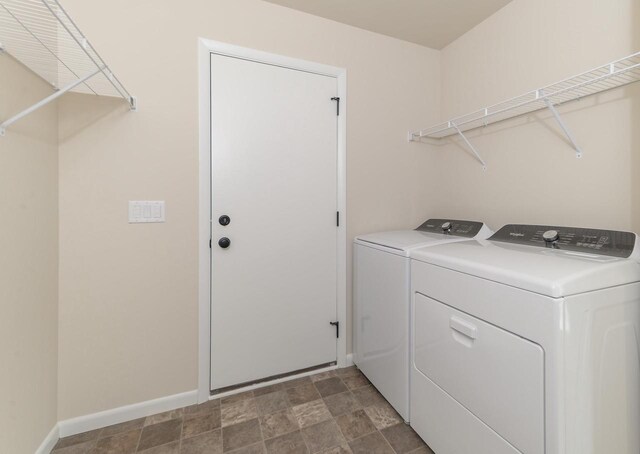 6407 Prairie Wood Dr, Mcfarland, WI 53558 - washroom with independent washer and dryer, stone finish flooring, baseboards, and laundry area