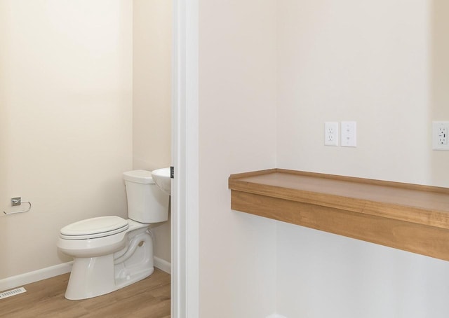 6407 Prairie Wood Dr, Mcfarland, WI 53558 - bathroom with visible vents, baseboards, wood finished floors, and toilet