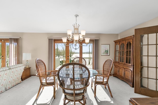 carpeted dining room with an inviting chandelier and a wealth of natural light