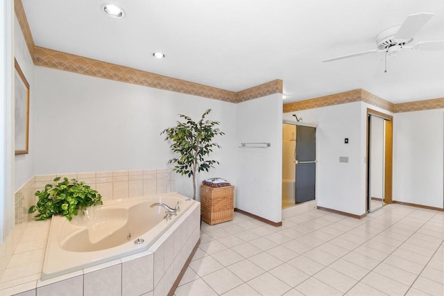 bathroom featuring tile patterned flooring, tiled bath, and ceiling fan