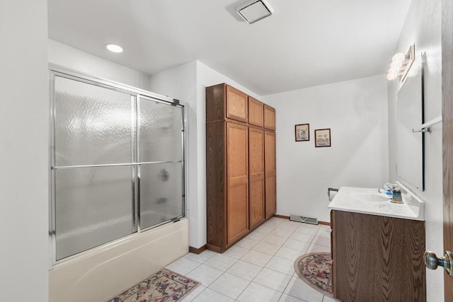 bathroom featuring vanity, tile patterned floors, and bath / shower combo with glass door