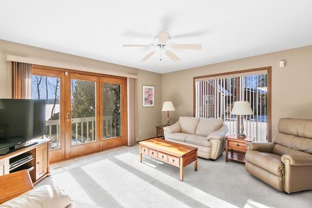 living room with light carpet and ceiling fan