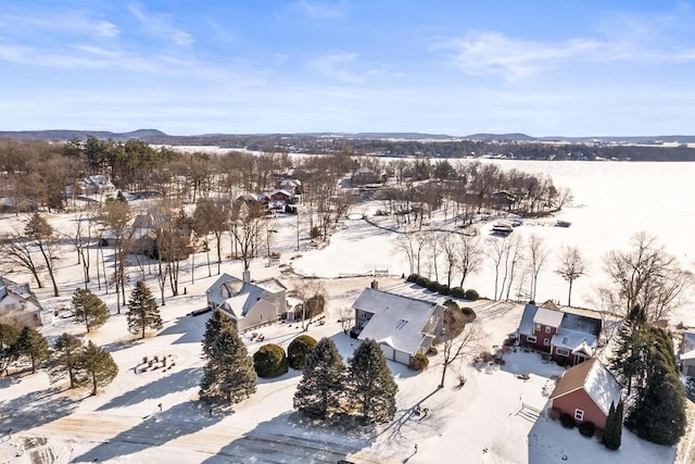 snowy aerial view featuring a mountain view