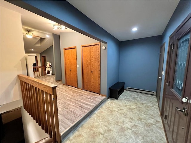 foyer with a baseboard radiator and track lighting