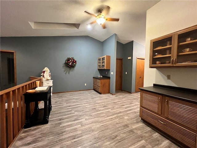 interior space with light wood-type flooring, ceiling fan, and lofted ceiling