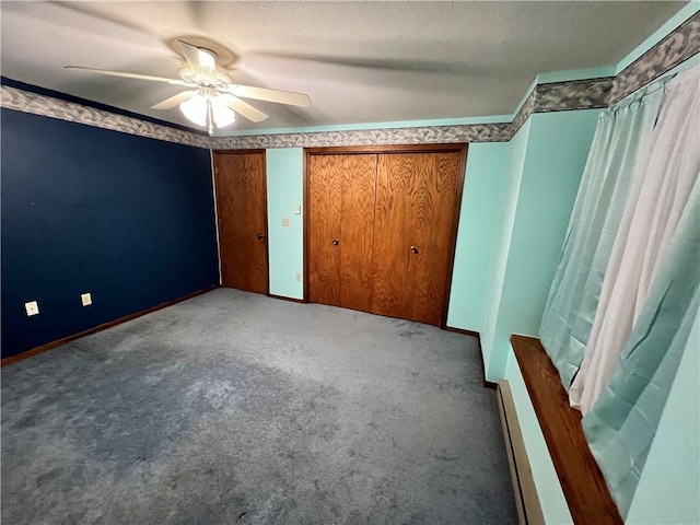 unfurnished bedroom with carpet, ceiling fan, and baseboard heating