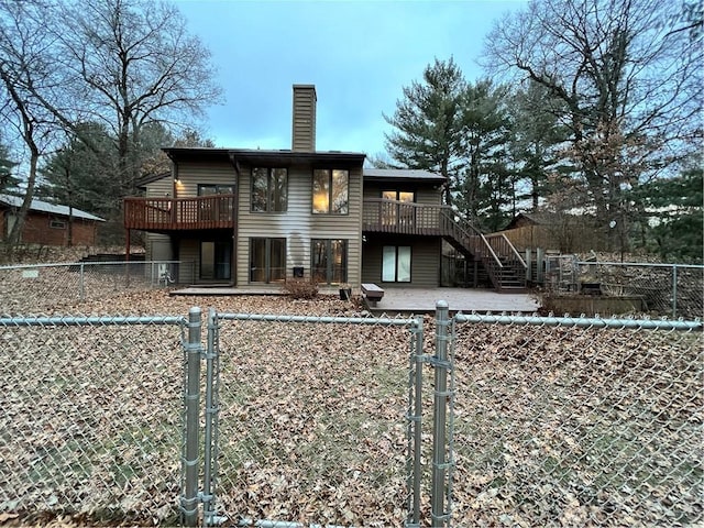 rear view of house featuring a wooden deck