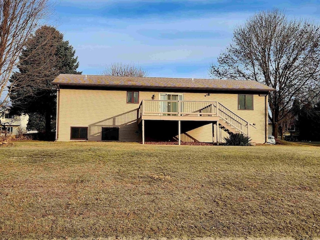 back of house featuring a deck and a lawn