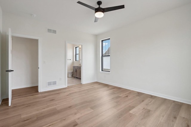 unfurnished bedroom featuring connected bathroom, ceiling fan, and light hardwood / wood-style floors