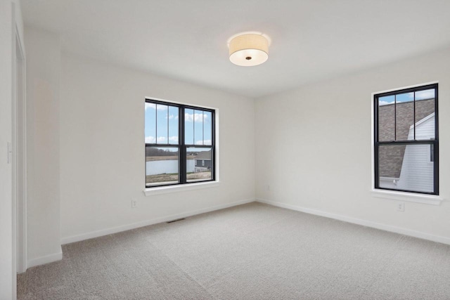 unfurnished room with plenty of natural light and carpet floors