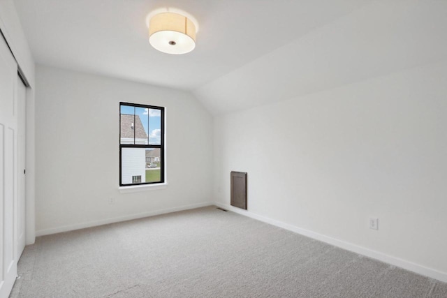 additional living space with carpet and lofted ceiling