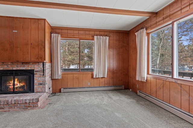 unfurnished living room featuring carpet flooring, a brick fireplace, and a baseboard heating unit