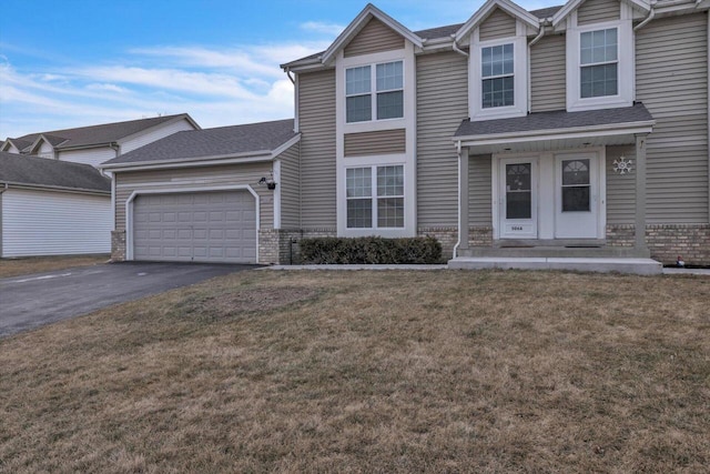 view of front of property with a garage and a front yard