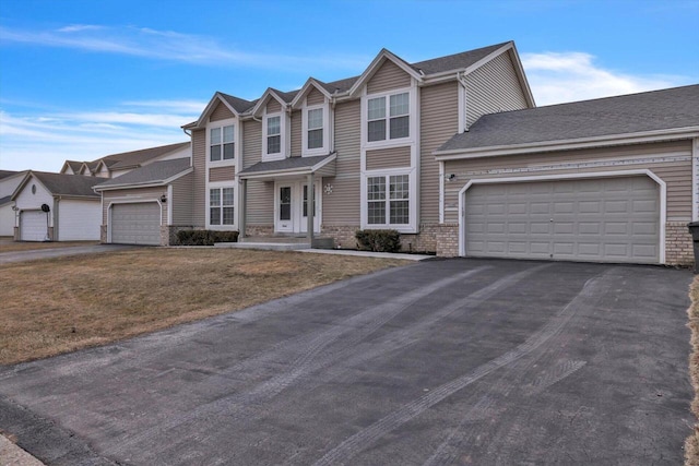 view of front of home with a front yard and a garage