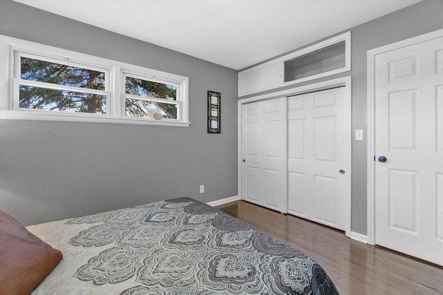 bedroom featuring dark hardwood / wood-style flooring and a closet