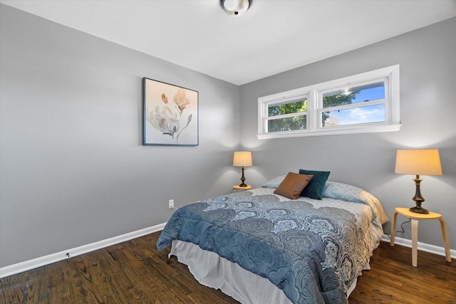 bedroom with dark hardwood / wood-style floors