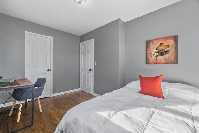 bedroom with dark hardwood / wood-style flooring