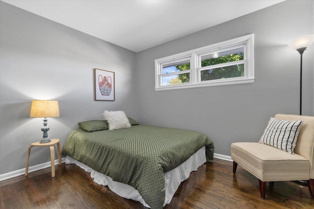 bedroom with dark hardwood / wood-style flooring