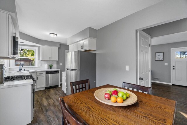 dining space with dark hardwood / wood-style floors and sink